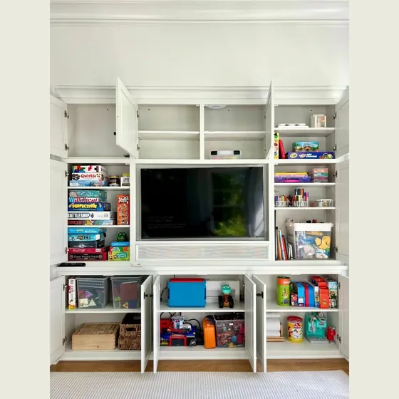 Family room built-ins with games, books and media neatly arranged
